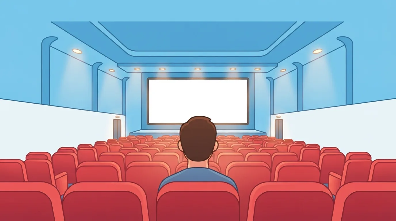 Empty movie theater auditorium facing a large screen