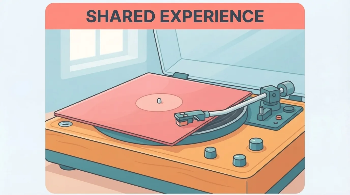Un vinile in una copertina rosa appoggiato su un giradischi in una stanza luminosa