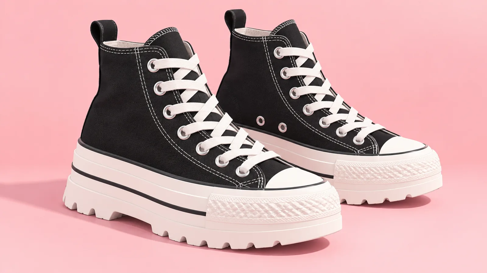 Zwarte canvas plateausneakers op een roze achtergrond